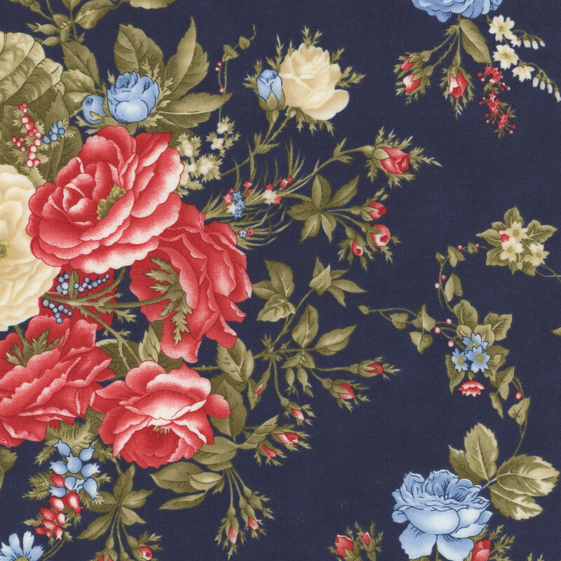 A section of a navy blue fabric with large red, cream and blue florals with large green leaves.