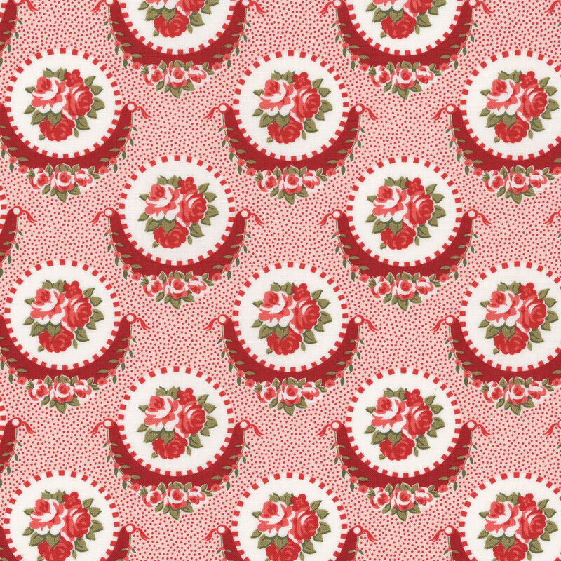 Section of a pink fabric with large red and white medallions with clustered pink flowers inside.