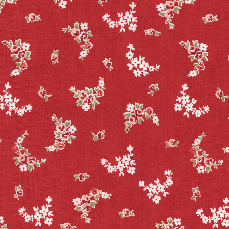 Section of a red fabric with scattered small pink and white flowers.