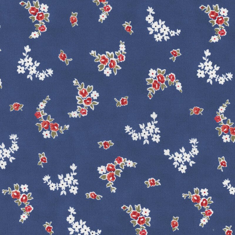 Section of a dark blue fabric with scattered small red and white flowers.