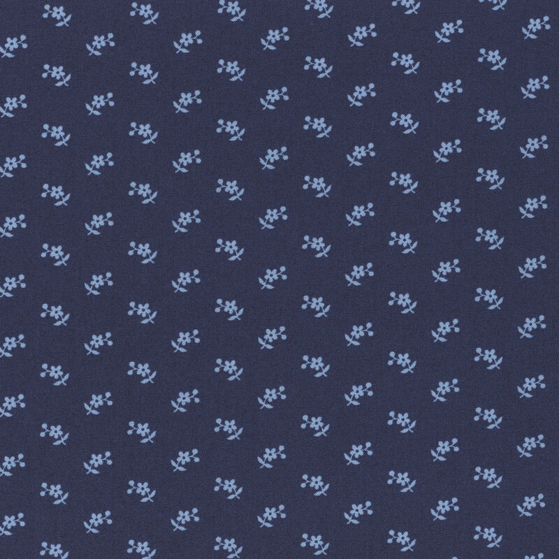 Section of a dark blue fabric with small lighter blue flowers and berries.