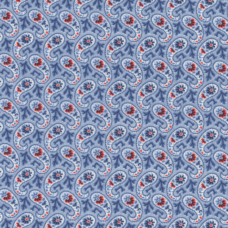 Section of a blue fabric with a paisley pattern made up of dark blue branches and red flowers.