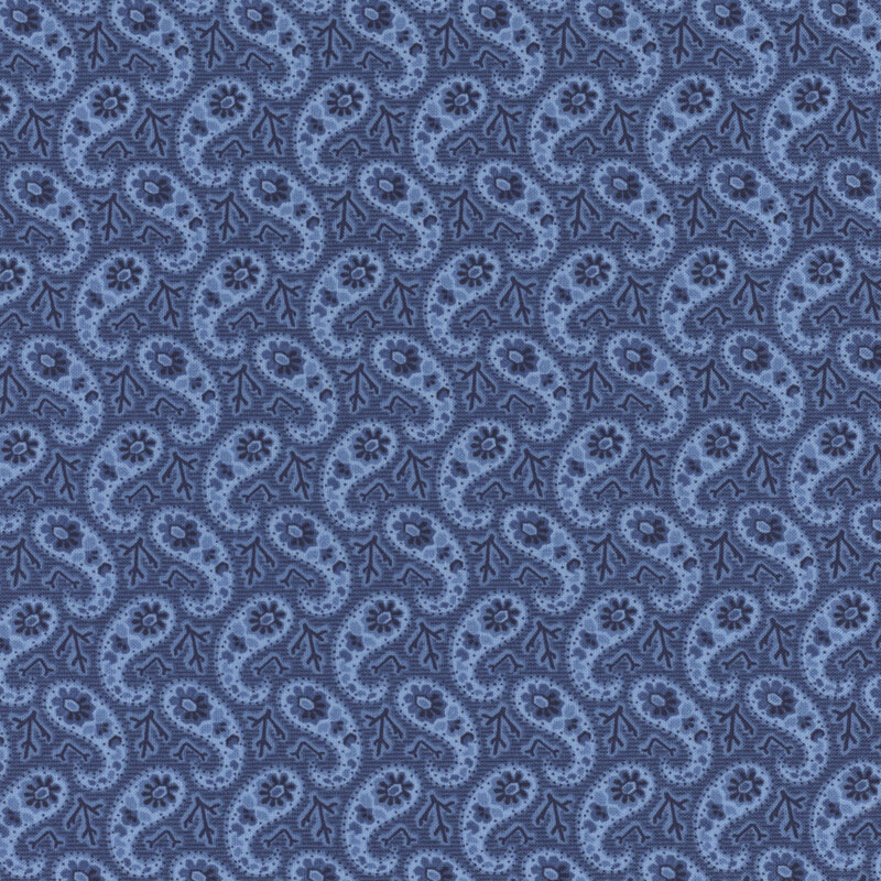 Section of a blue fabric with a paisley pattern made up of blue branches and flowers.