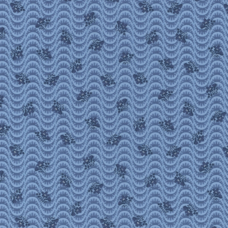 Section of a blue fabric with wavy lines and tossed navy blue ditsy florals