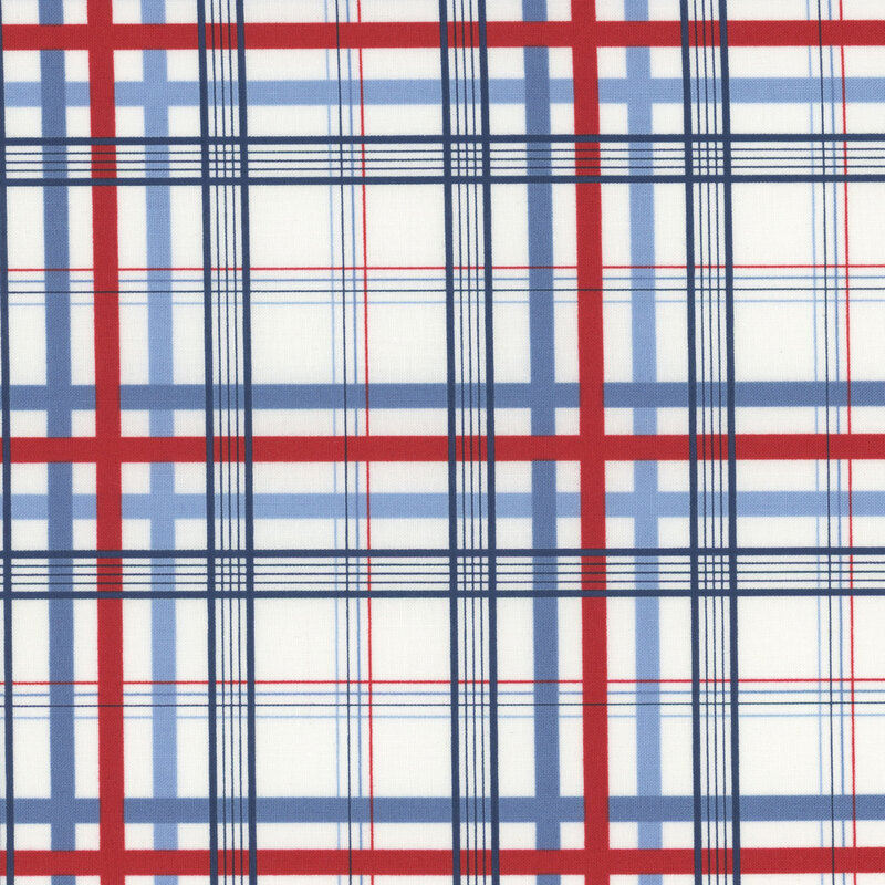 Section of a cream fabric with a red and blue plaid pattern.