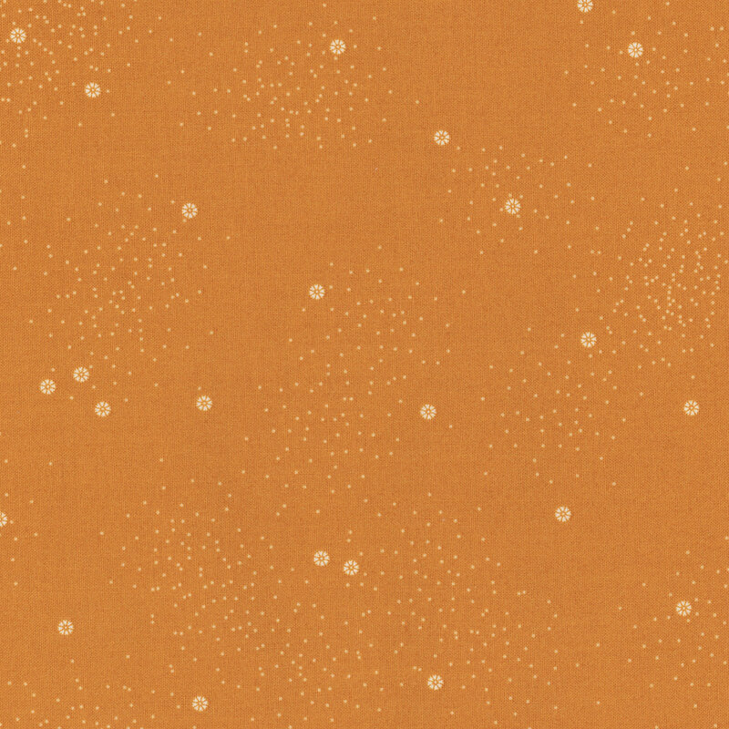 A butterscotch colored fabric with small white daisies and little white speckles throughout