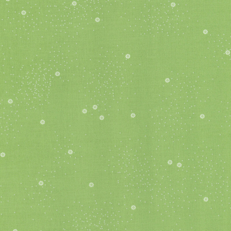 A grass-green fabric with small white daisies and little white speckles throughout
