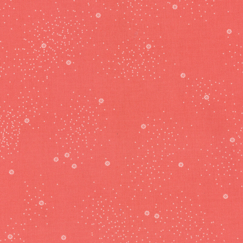 A coral-red fabric with small white daisies and little white speckles throughout