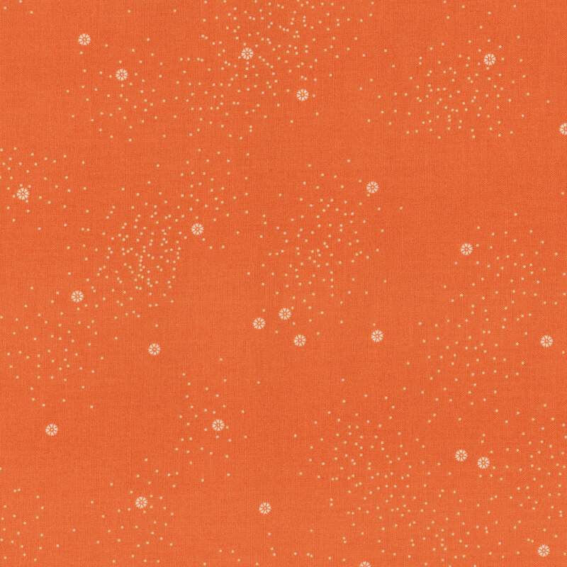 An orange fabric with small white daisies and little white speckles throughout