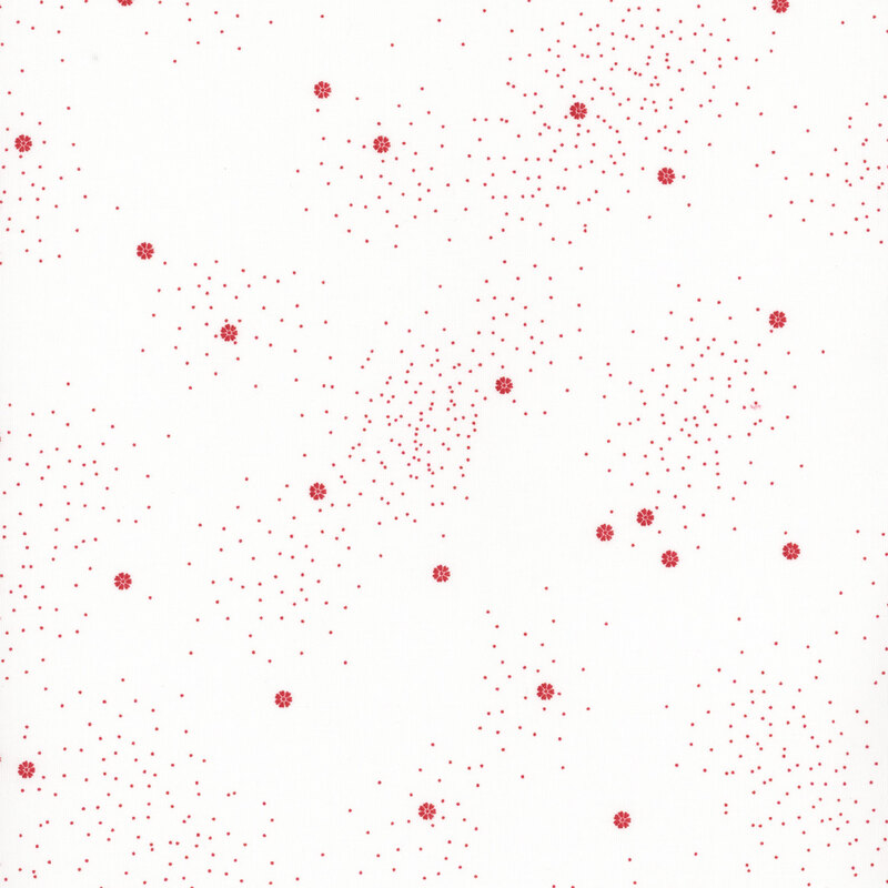 A white fabric with small red daisies and speckles throughout