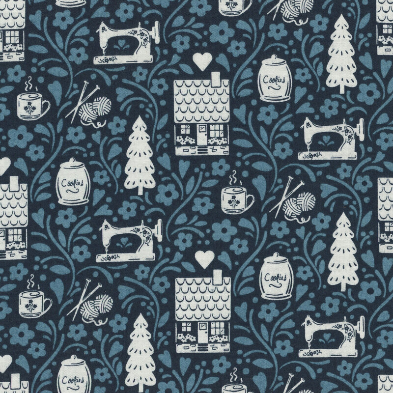 A section of fabric featuring off white cottages, trees, sewing machines, and hearts against a tonal blue background with vines and florals