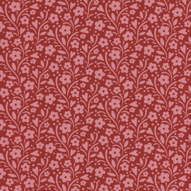 Tonal red fabric with pink leaves, vines, and florals all over