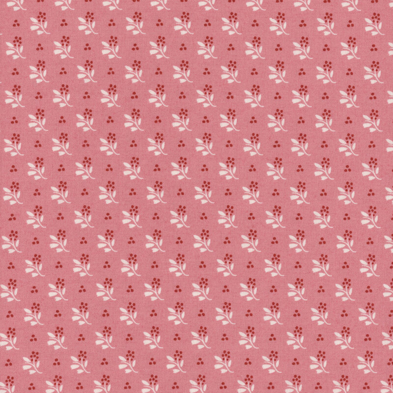 Pink fabric with small floral clusters all over featuring light cream stems and bold red flowers