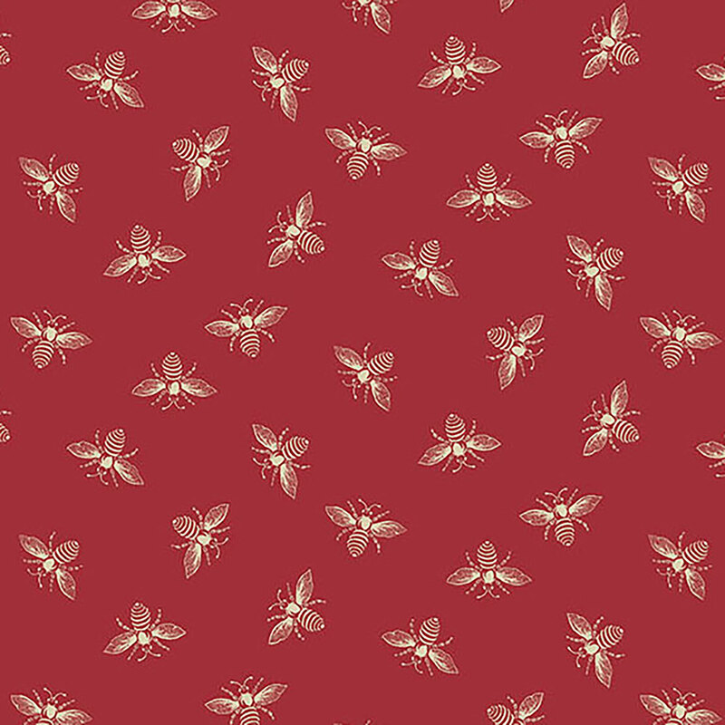 Apple red fabric with off-white ditsy bees all over.