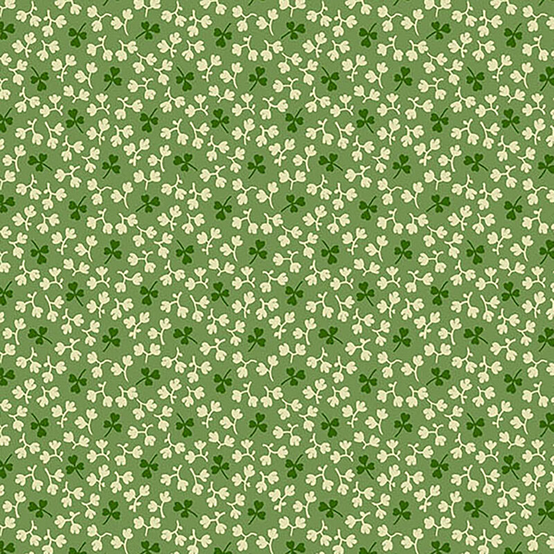 Forest green fabric with tossed dark green shamrocks and little off-white leaves all over