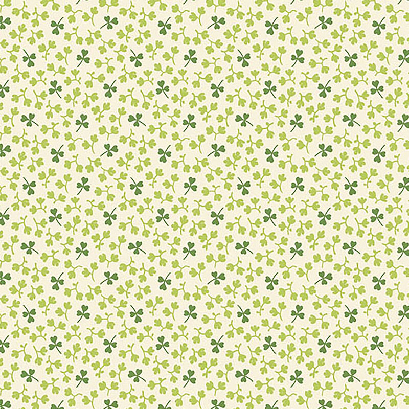 Light cream fabric with small dark green shamrocks and light green leaves all over