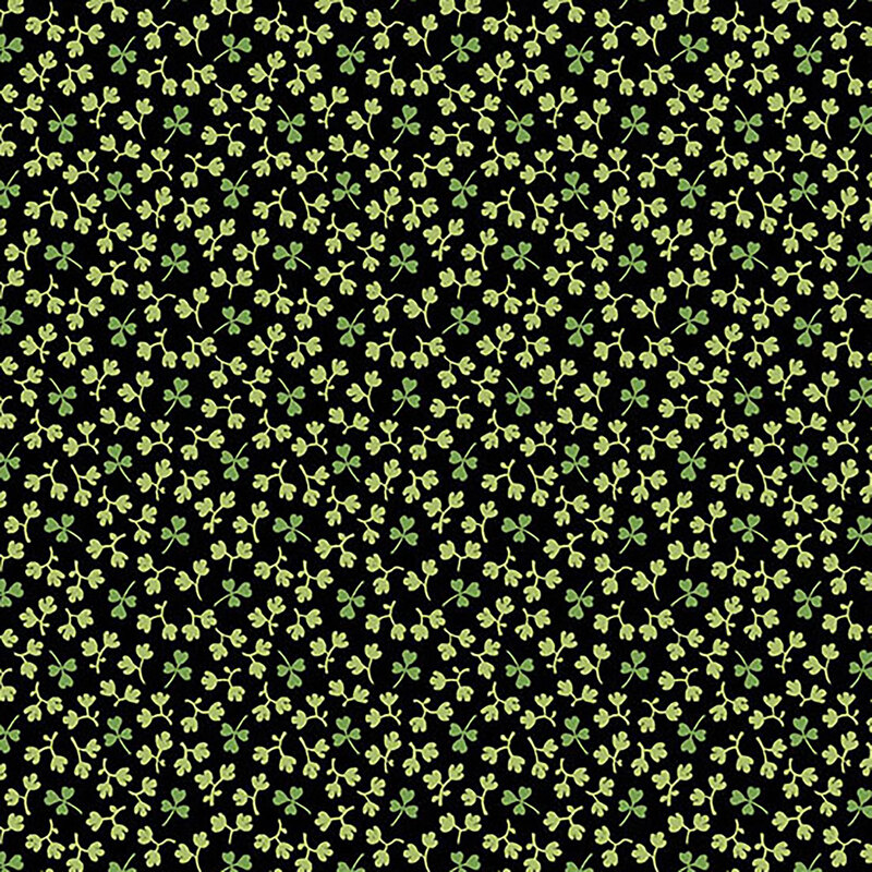 Solid black fabric covered in little green shamrocks and off-white leaves
