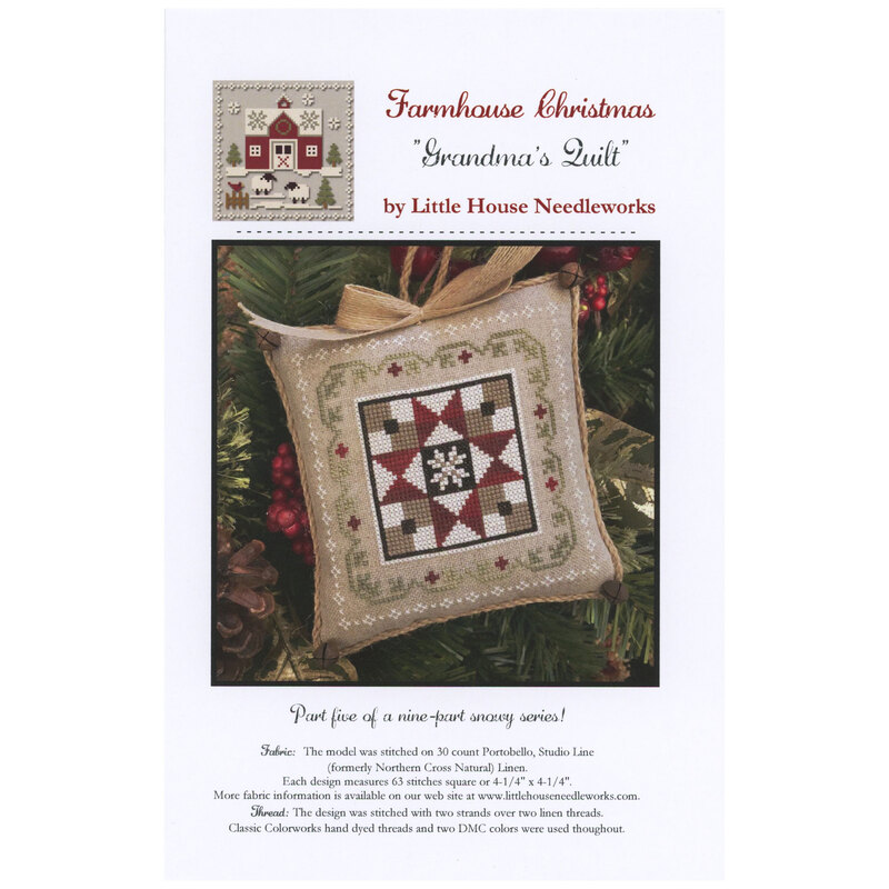 Front of pattern showing the completed small cross stitch ornament staged with holly on the branch of a Christmas tree