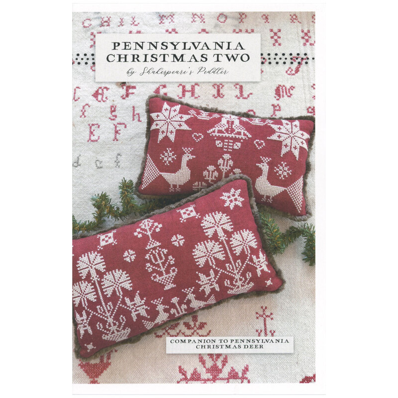 Front of pattern showing the completed cross stitch pillows staged on a cloth with letters in the background