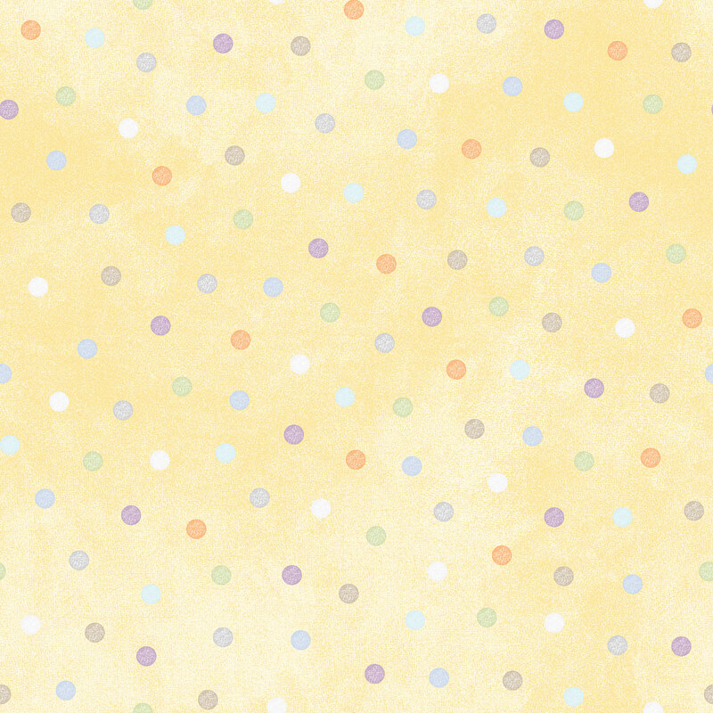 soft pastel yellow fabric featuring pastel multicolored polka dots