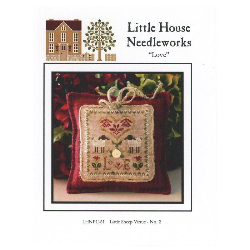 Front of pattern showing the completed cross stitch on a small ornament pillow in front of flowers and leaves