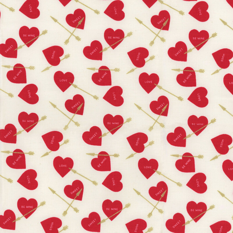 White fabric with ditsy red hearts and golden arrows throughout