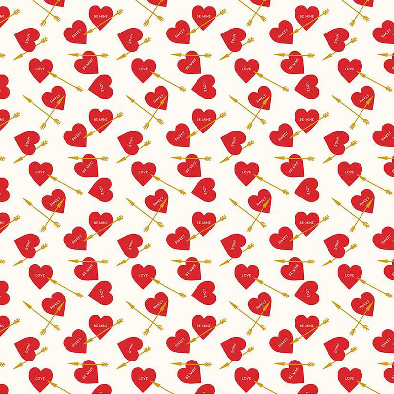 White fabric with ditsy red hearts and golden arrows throughout