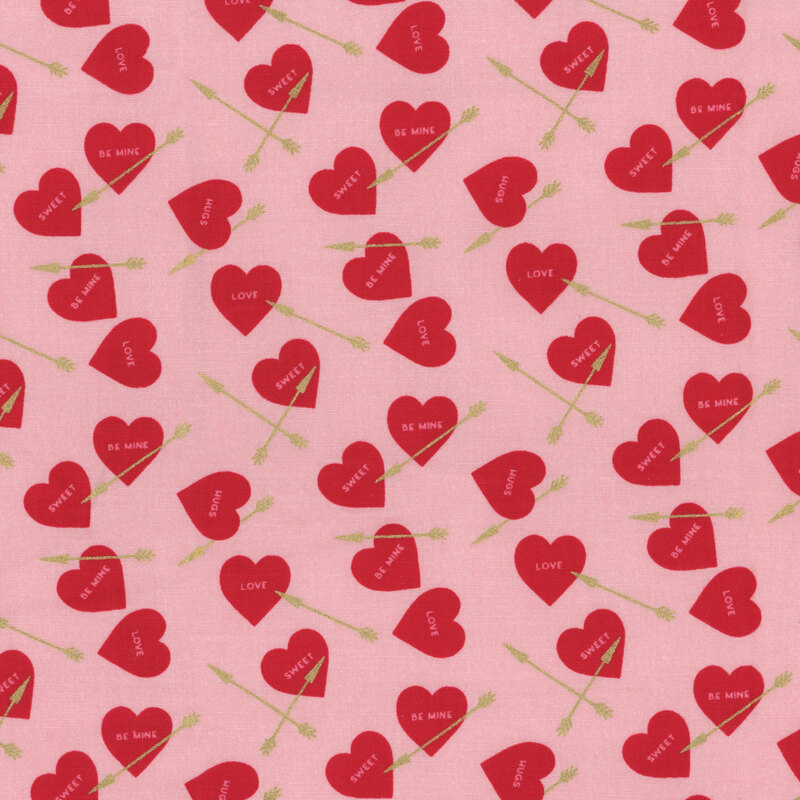 Light pink fabric with small, red ditsy hearts and gold arrows throughout