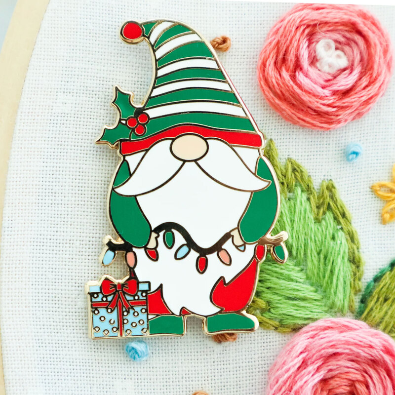 The Christmas gnome needle miner displayed on a hand embroidery project 