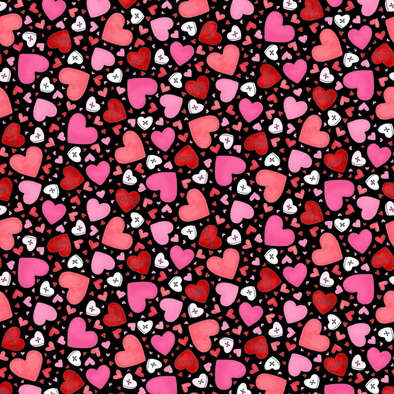 Black fabric covered in pink, red, and white hearts of varying sizes