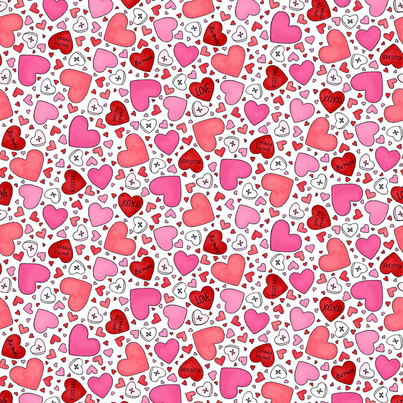 White fabric covered in red, pink, and white hearts of varying sizes
