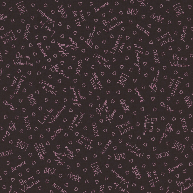Black fabric with pink outlines of hearts and Valentine's Day sayings like 