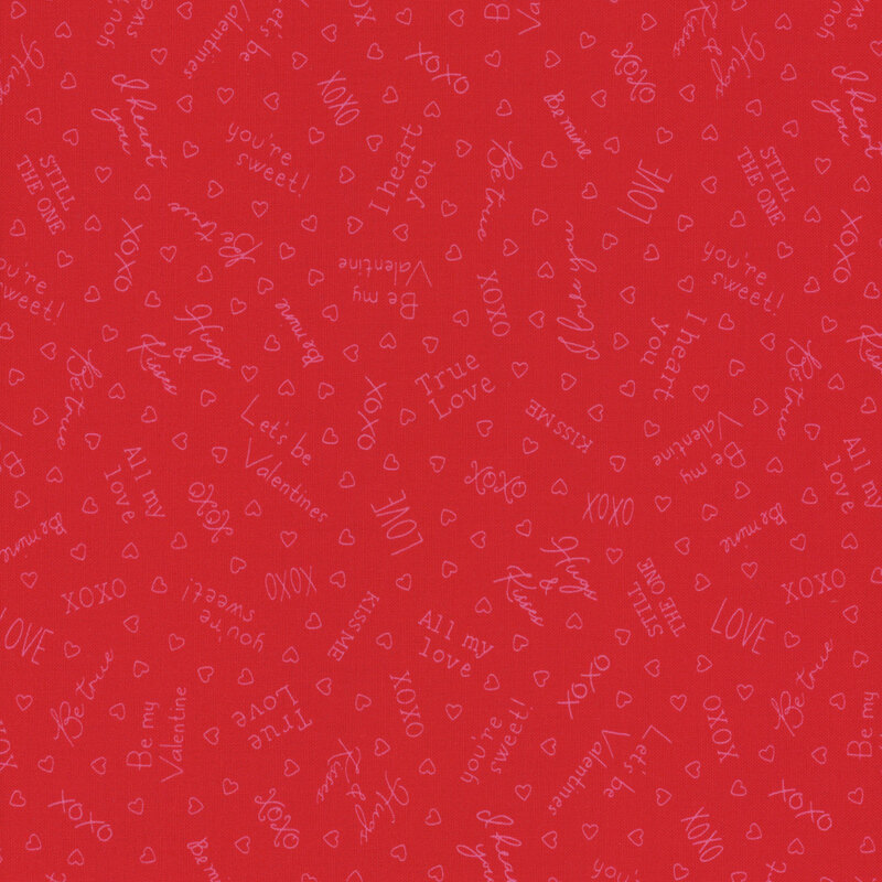 Red fabric with pink outlines of hearts and Valentine's Day sayings like 