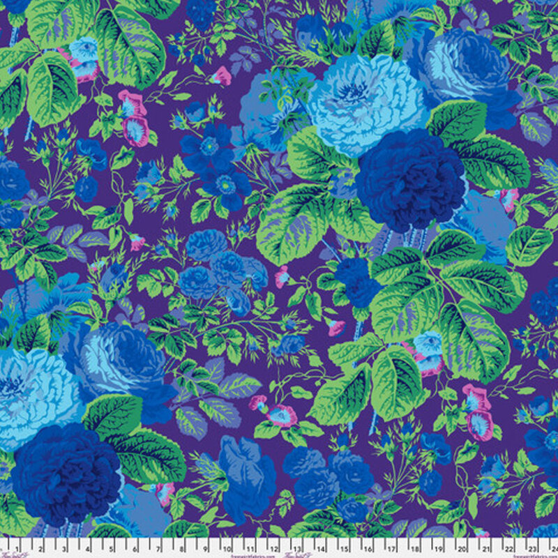 Deep purple fabric covered in scattered large bright and royal blue florals with large green leaves surrounded by small green leaves and vines