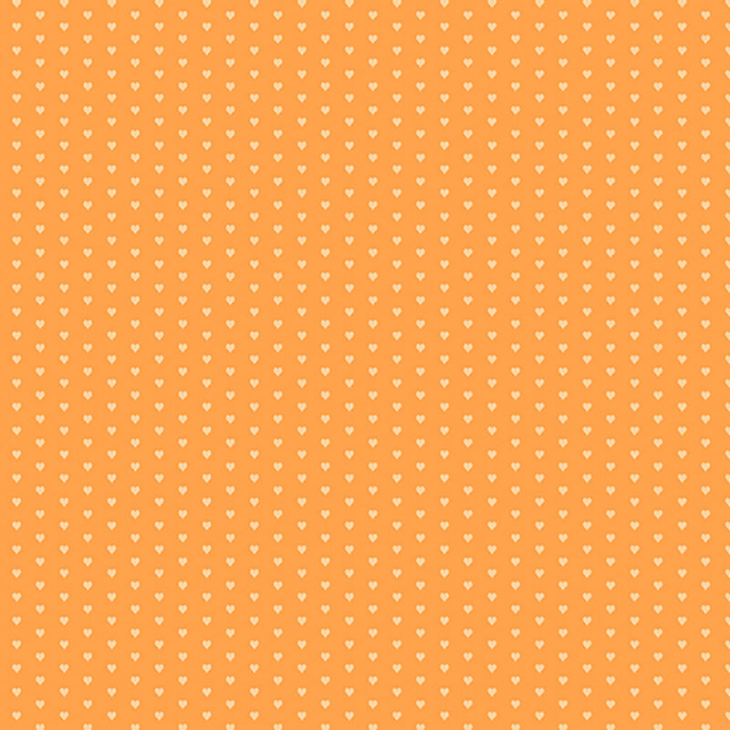 Orange fabric with a pattern of mini light peach hearts