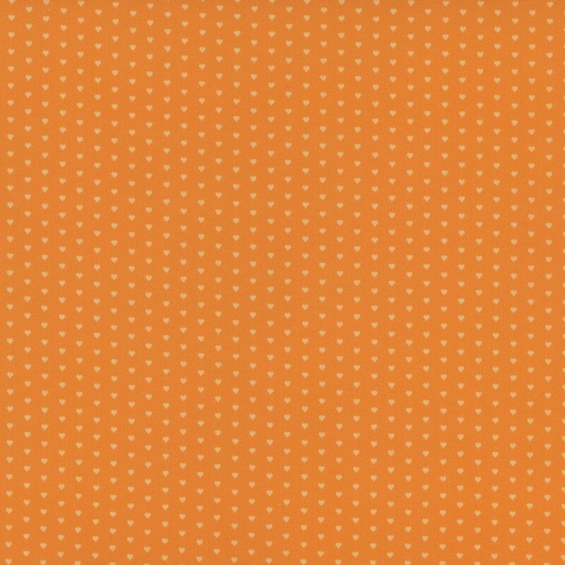 Orange fabric with a pattern of mini light peach hearts