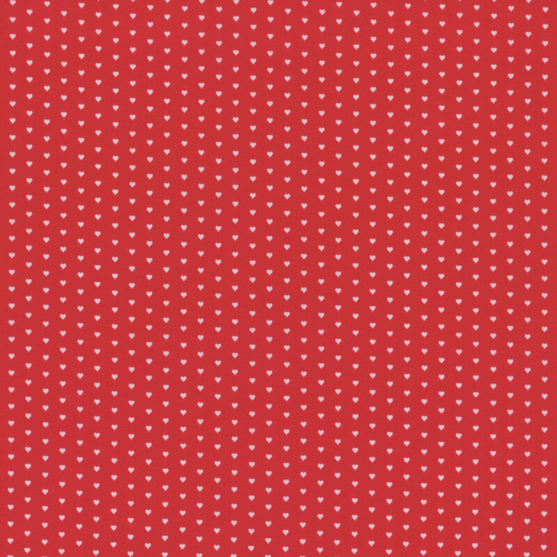 Bright red fabric with a pattern of mini white hearts