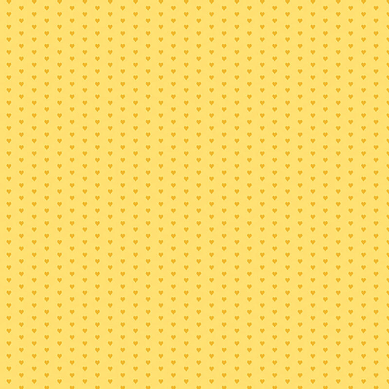 Yellow fabric with a pattern of mini golden hearts
