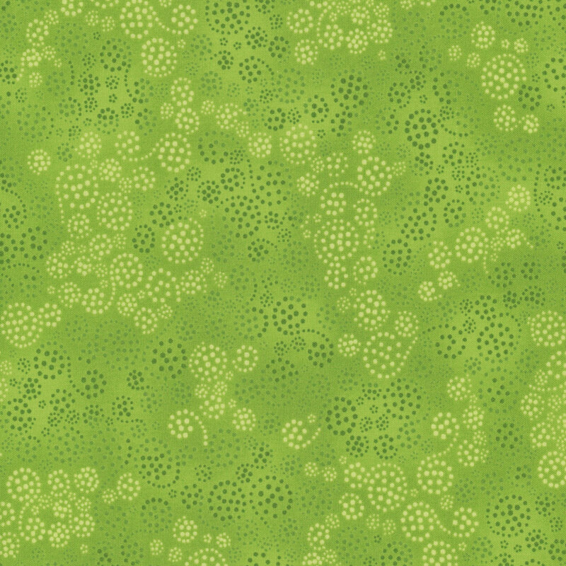 Lime green fabric featuring dark green and cream dotted swirls