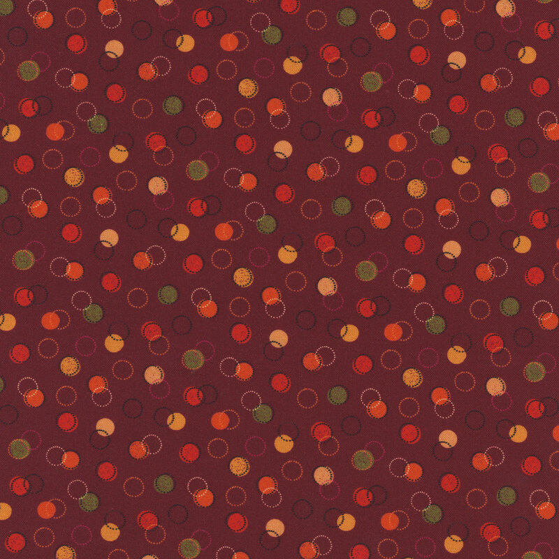 red fabric with various green, red, and yellow dots