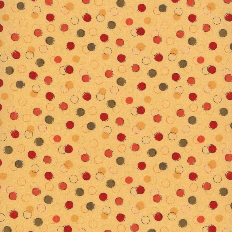 cream fabric with various green, red, orange, and yellow dots