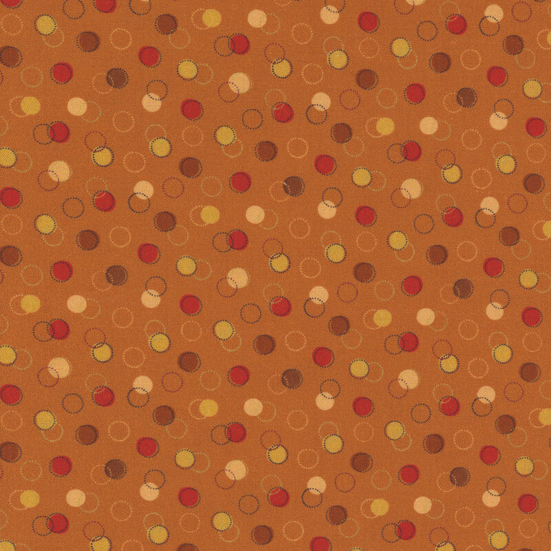 orange fabric with various brown, red, and yellow dots