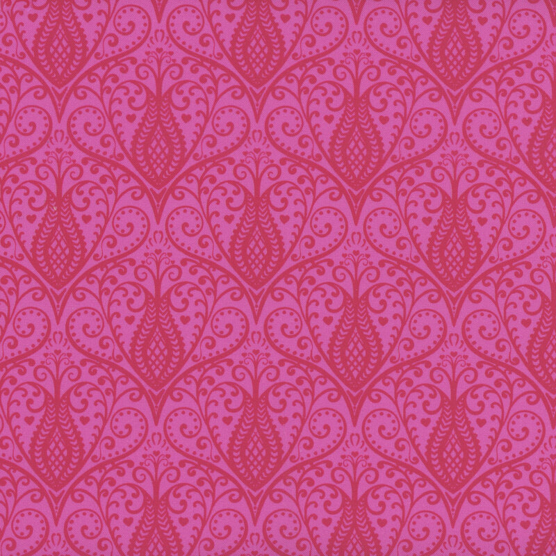 Bright pink fabric with damask like repeating designs of swirling florals