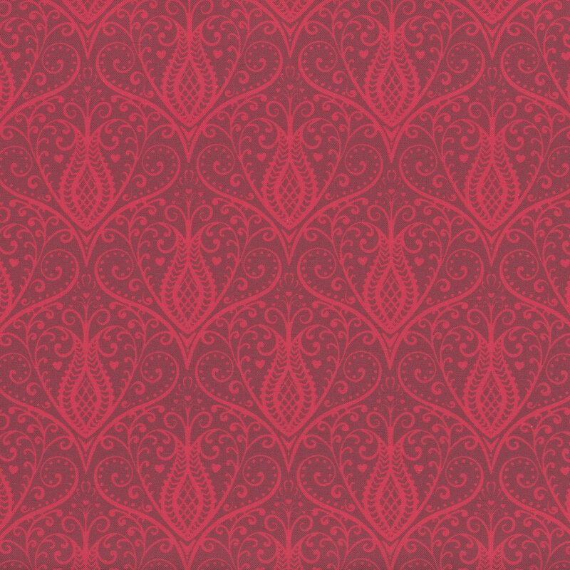 Tonal scarlet red fabric with damask like repeated red floral designs throughout