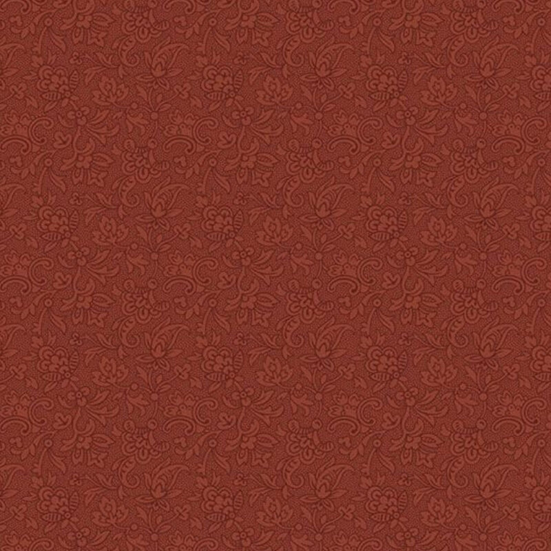 Tonal brick red fabric with an intricate floral design