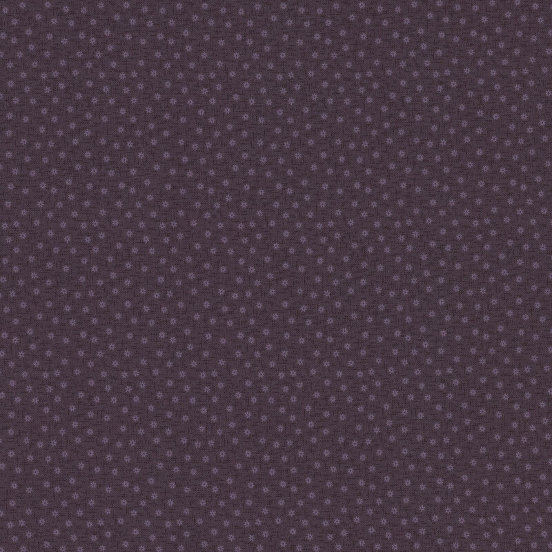 purple textured fabric with tiny gear-like flowers 