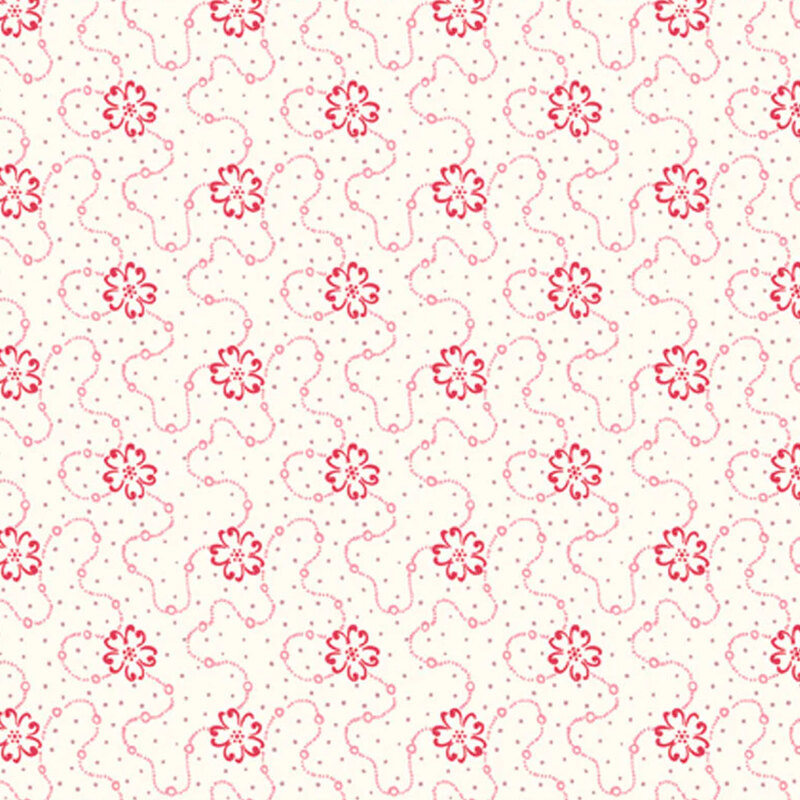 Cream fabric featuring a swirly dotted design with red flowers and scattered gray dots