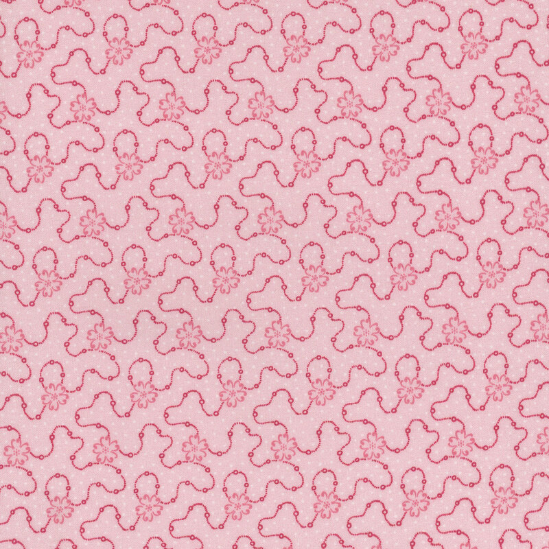 Light pink fabric featuring a swirly dotted design with pink flowers and scattered white dots