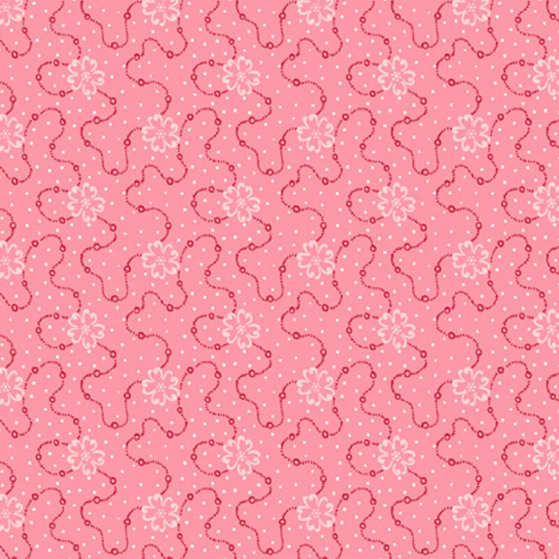 Pink fabric featuring a swirly dotted design with white flowers and scattered white dots