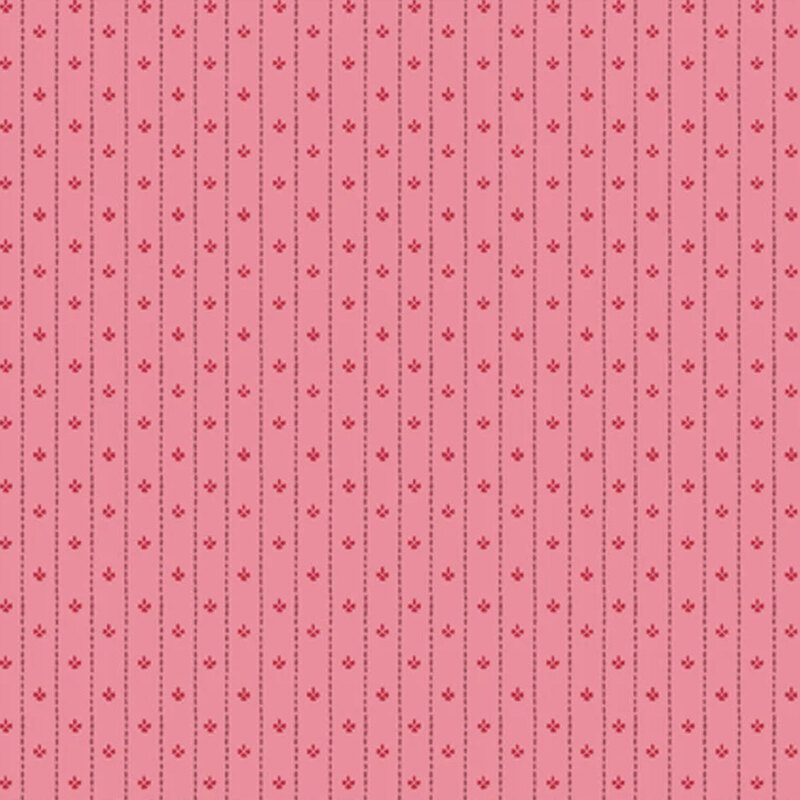 Pink fabric featuring striped dotted lines and red florals in between